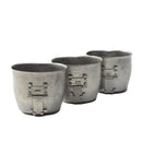 Three vintage Austrian army stainless steel canteen cups with folding handles lined up on white background