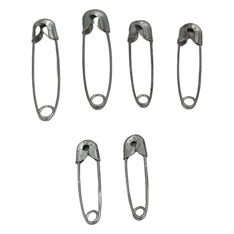 Set of six metal safety pins on a white background
