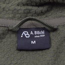 Close-up of the A. Blochl brand label on an olive military-style fleece thermal jacket size medium
