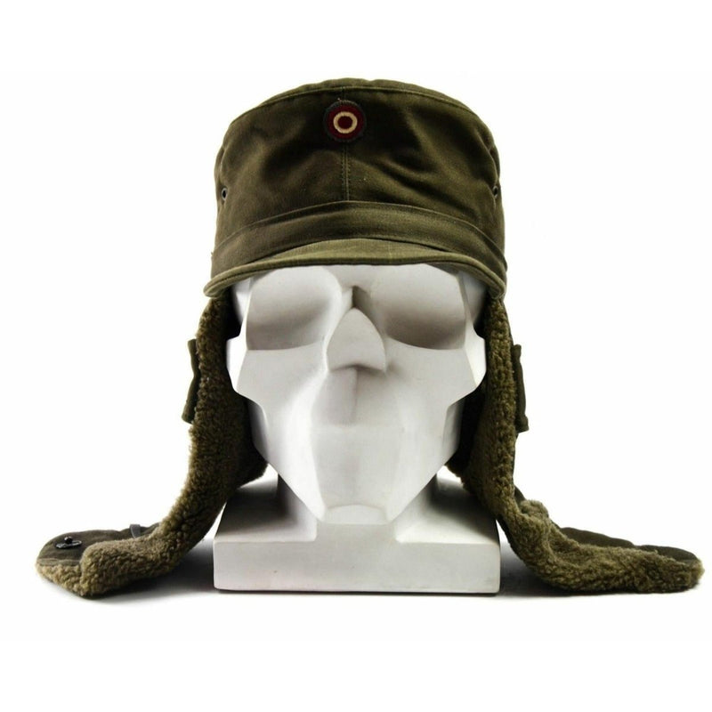 Genuine Austrian Army olive winter cap with insignia badge and faux fur ear flaps on white mannequin head