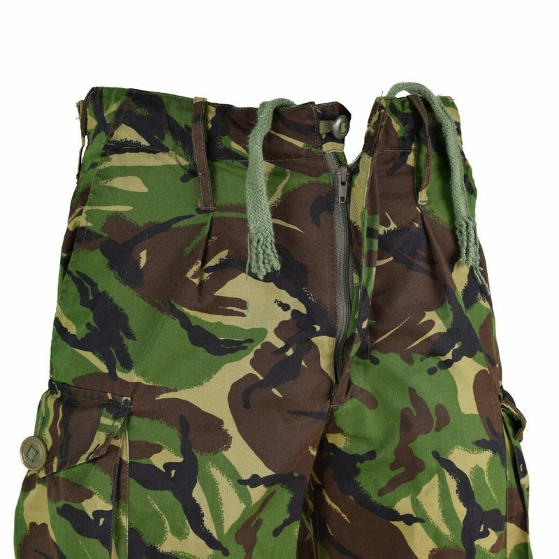 Genuine British Army DPM combat trousers in woodland pattern with cargo pockets and adjustable waist tabs.