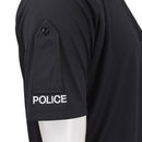 Close-up of black breathable police polo shirt sleeve with authentic embroidered "POLICE" insignia and buttoned detail