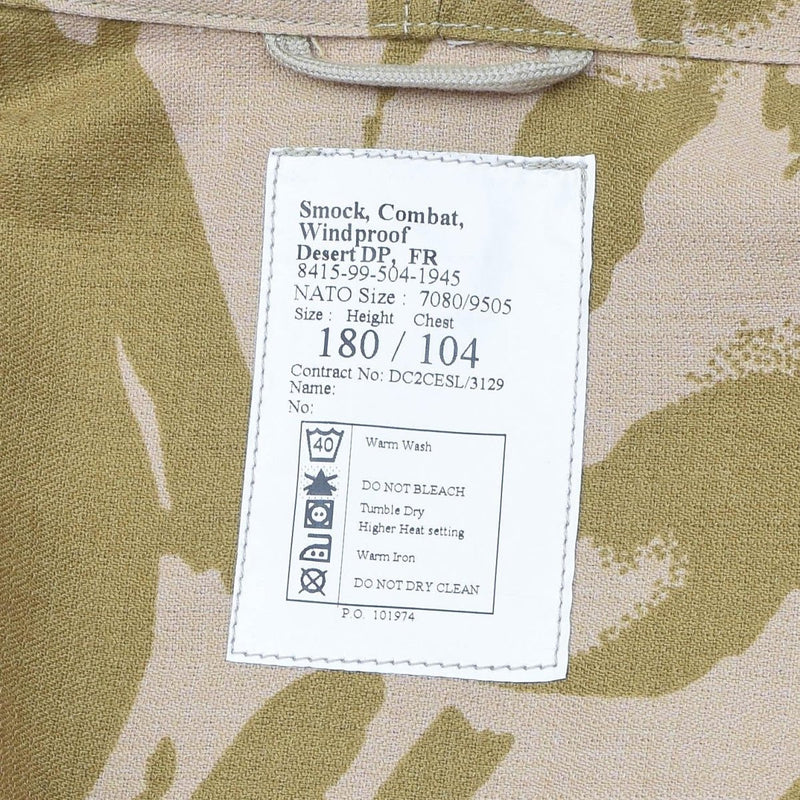 Label on British military smock jacket showing size, care instructions, and desert camouflage fabric details.