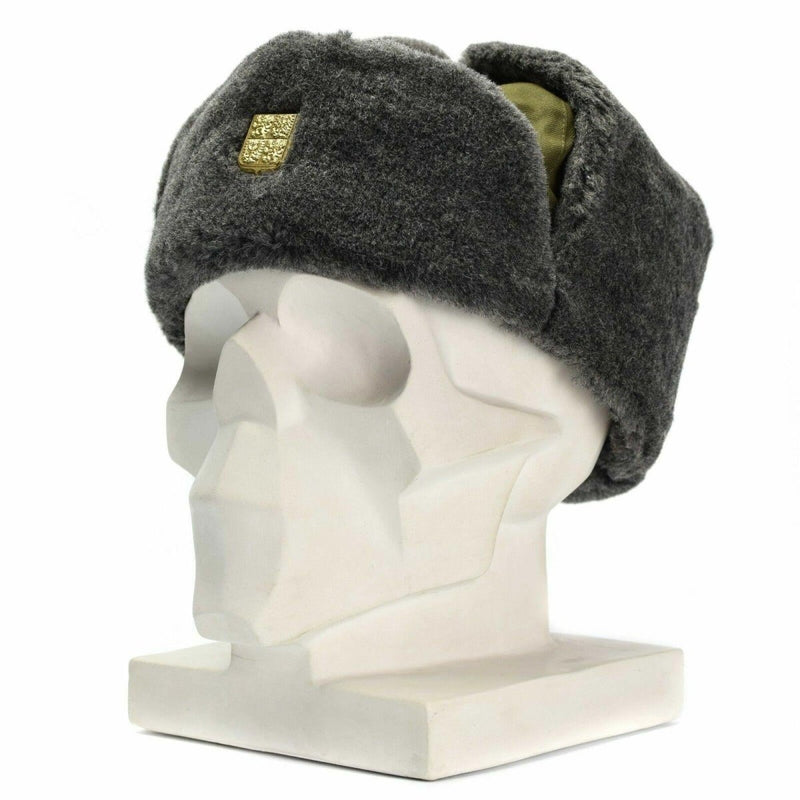 Vintage Czech army winter ushanka hat in gray faux fur with olive lining and gold badge displayed on a mannequin head