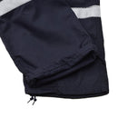 Close-up of dark blue French navy marine jumpsuit leg with reflective bands and adjustable drawstring hem.