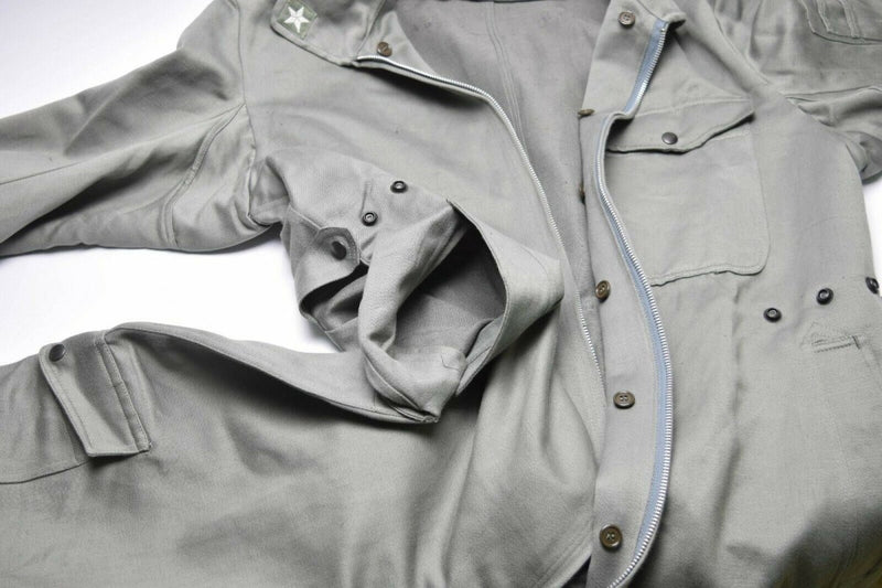 Genuine Italian Army military grey coverall suit with zip-front and buttoned pockets laid flat on white background.