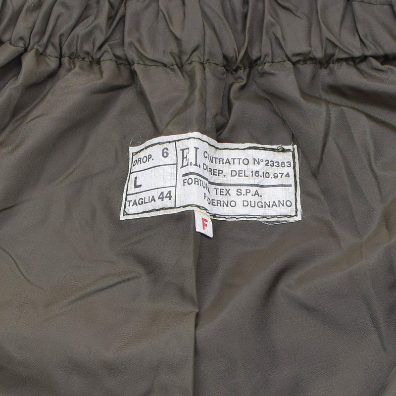 Close-up of label on genuine Italian military rain pants OD olive thermal lined waterproof trousers