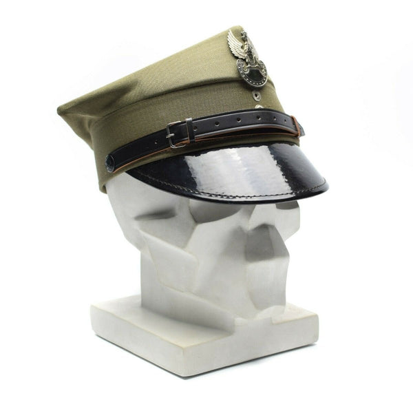 Genuine Polish military peaked cap in olive with eagle insignia and adjustable chinstrap, symbolizing tradition and honor.