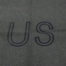 Text 'US' embossed on a textured gray surface