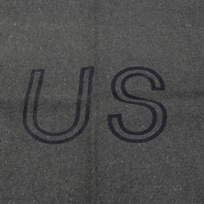 Text 'US' embossed on a textured gray surface