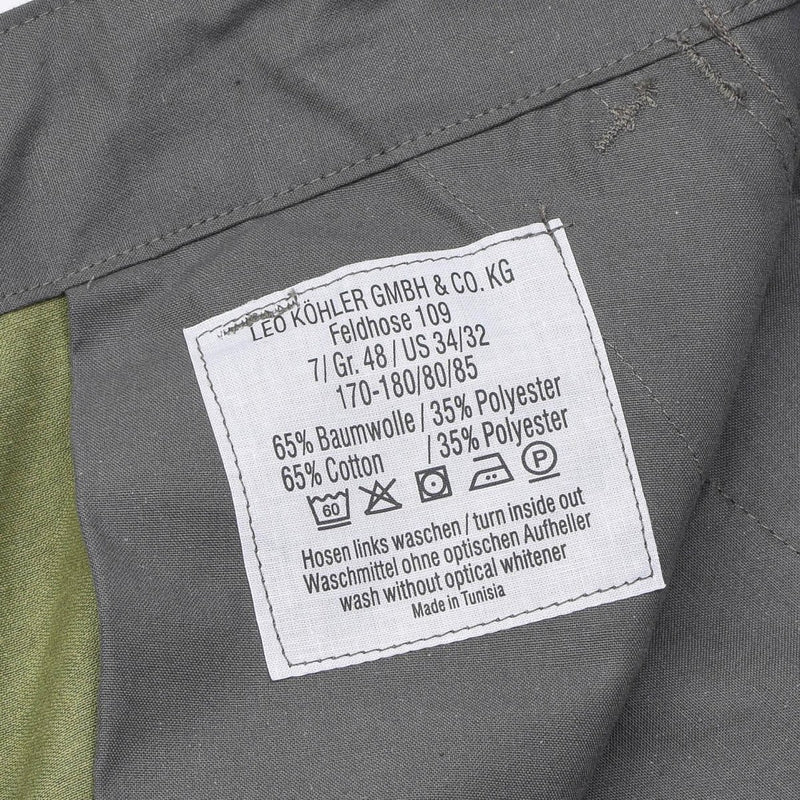 Close-up of Leo Kohler BDU pants care label showing material, size, and washing instructions in German and English