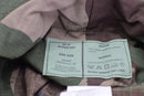 Close-up of Mil-Tec US GI boonie hat label showing size, material, and care instructions on CCE camo fabric.