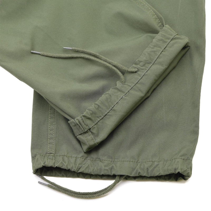 Close-up of olive drab Mil-Tec U.S. Army M64 Vietnam jungle style combat pants adjustable cuffs and drawstrings.