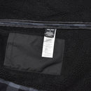 Close-up of MIL-TEC German Military Lumberjack jacket inner pocket and label on warm black gray fleece lining