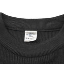 Close-up of dark green wool blend Belgian military sweater crew neck showing fabric texture and care label.