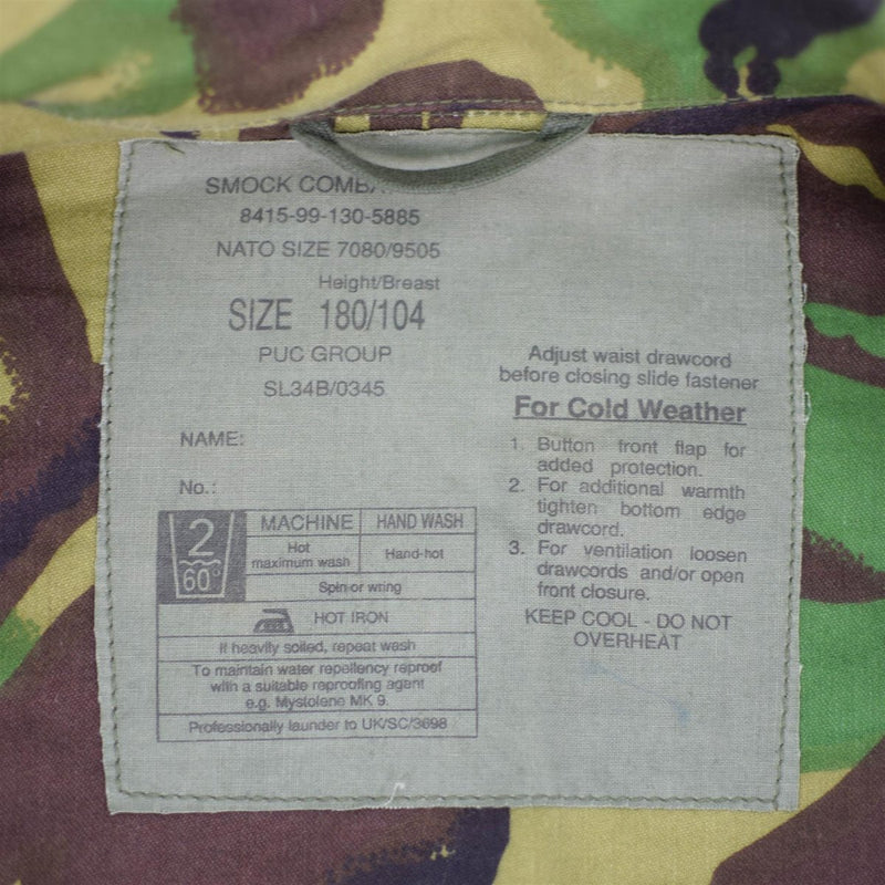 Close-up of label inside British army BDU combat smock jacket showing size, care instructions, and cold weather adjustments.