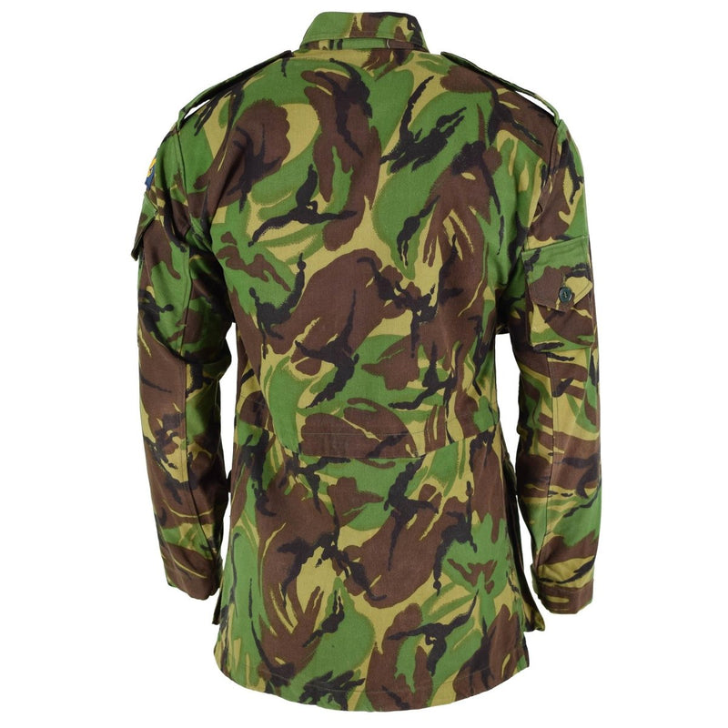 Back view of British Army BDU combat smock jacket in woodland camo with epaulets and adjustable cuffs and waist