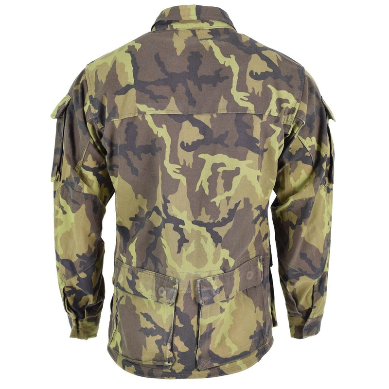 Back view of original Czech army field jacket with leaf camo pattern and multiple tactical pockets.
