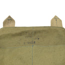 Close-up of vintage green canvas Czech military gas mask shoulder bag with faded stamped markings and stitched loops.