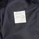 Close-up of the sewn-in care label inside the Original Dutch Military men's blue raincoat with quilted liner.