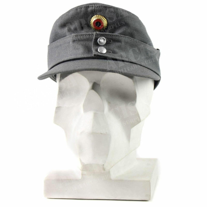Original German army Gebirgsjäger grey mountain cap with flat top, peaked front, and metal buttons on white display bust.