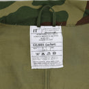 Close-up of label inside Original Italy military combat jacket with care instructions and size details in woodland camo fabric