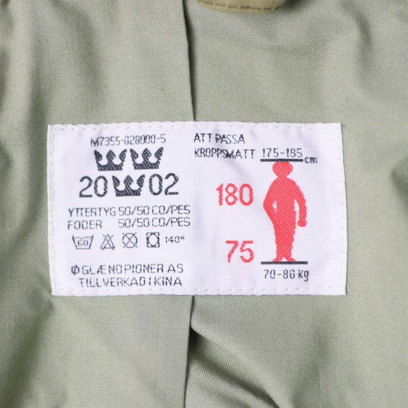 Close-up of size and care label inside Original Swedish army M90 splinter camouflage combat jacket detailing fabric and fit.