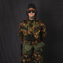 Swiss military Alpen camouflage coverall suit worn by soldier with helmet, goggles, binoculars, and utility belt pouches.