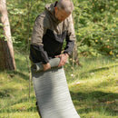 Man rolling up an Original U.S. military Therm-A-Rest lightweight self-inflating sleep pad outdoors