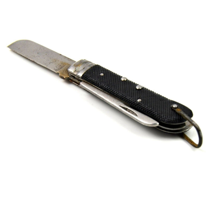 Vintage Italian army navy folding pocket knife with black handle and partially extended blade on white background