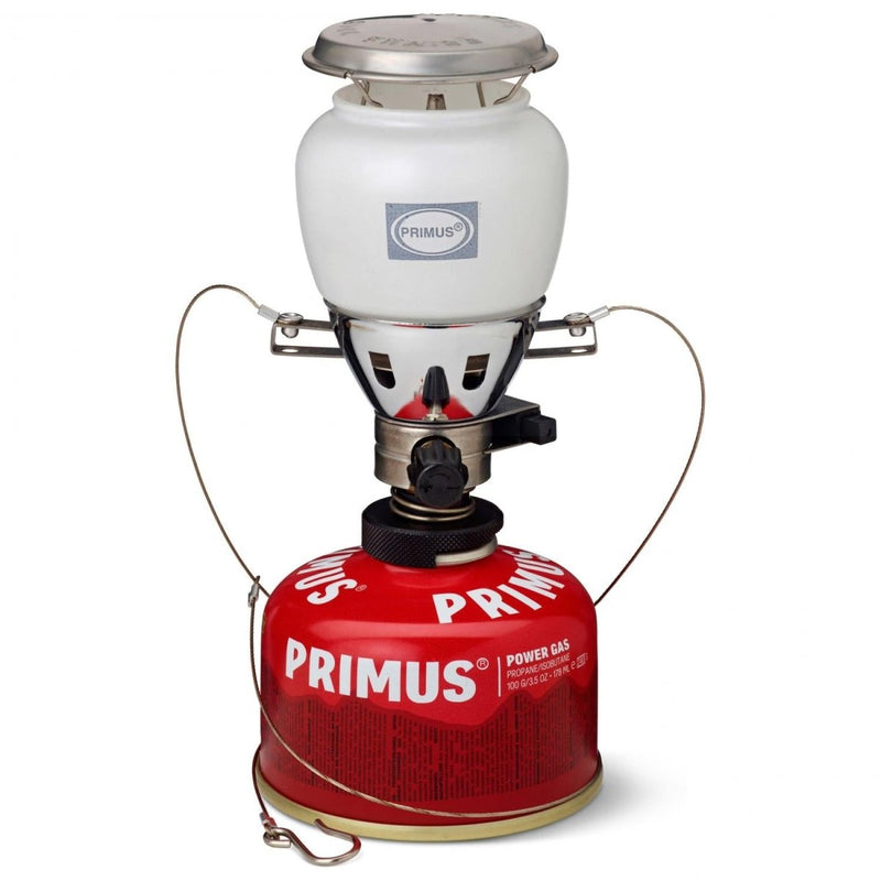 Primus EasyLight Duo gas lantern with white glass globe and red gas canister for camping and hiking illumination.