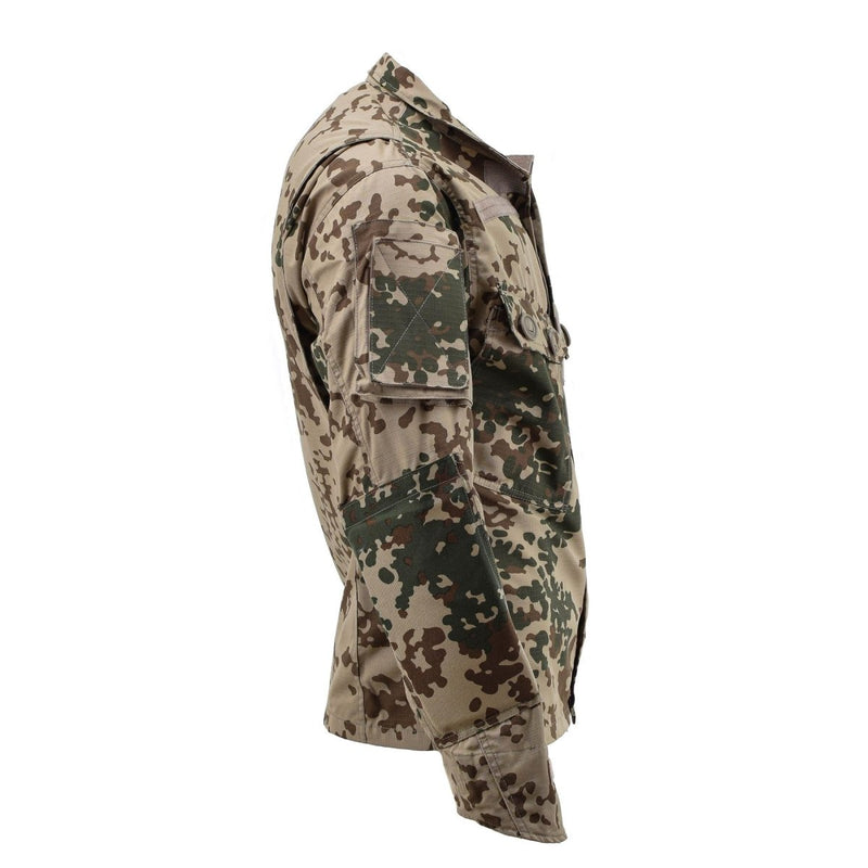 Side view of TACGEAR Military style commando field jacket in desert flecktarn camouflage pattern with buttoned pockets